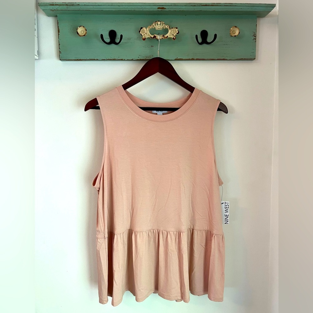 Sleeveless, crew-neck, baby doll top. Rayon/spandex blend.